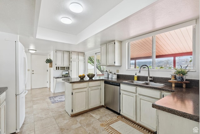1074 E Spring Ridge Dr, Sandy, UT 84094 - kitchen featuring stainless steel dishwasher, freestanding refrigerator, dark countertops, and a peninsula