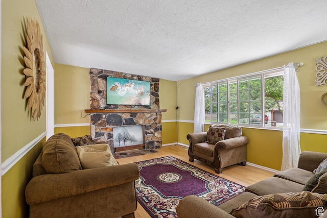 601 E Hilo St S, Sandy, UT 84070 - living area with wood finished floors, a textured ceiling, and a fireplace