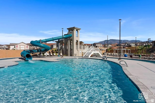1210 N Mistico Aly, Washington, UT 84780 - community pool with a water slide, a mountain view, and a patio