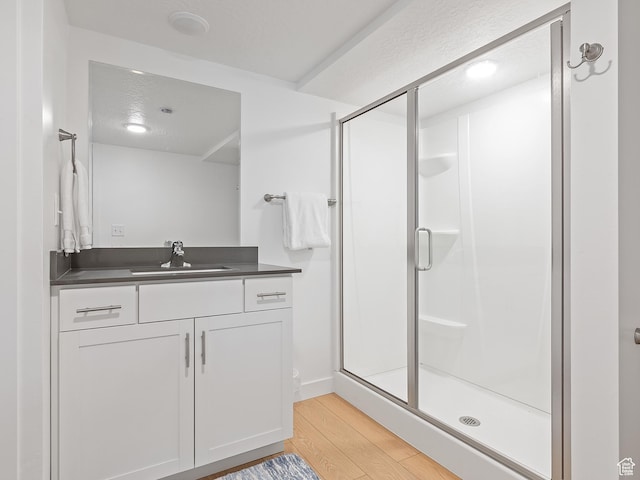 2309 N Wildwood Ln, Heber City, UT 84032 - full bath featuring wood finished floors, a stall shower, and vanity