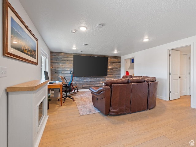 2309 N Wildwood Ln, Heber City, UT 84032 - living area with wood walls, light wood-type flooring, a textured ceiling, an accent wall, and recessed lighting