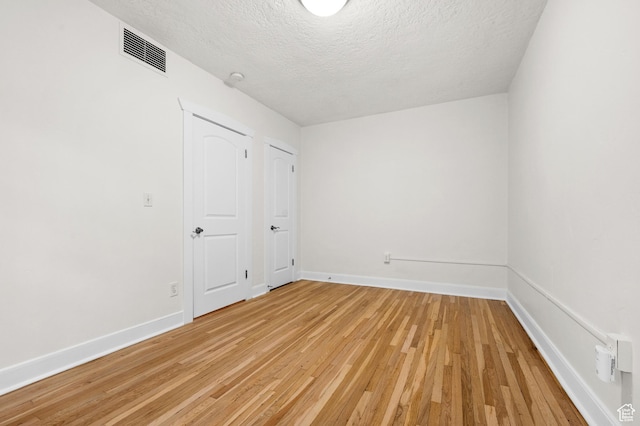 555 E 100 S Unit 303, Salt Lake City, UT 84102 - unfurnished bedroom with a textured ceiling and light wood finished floors