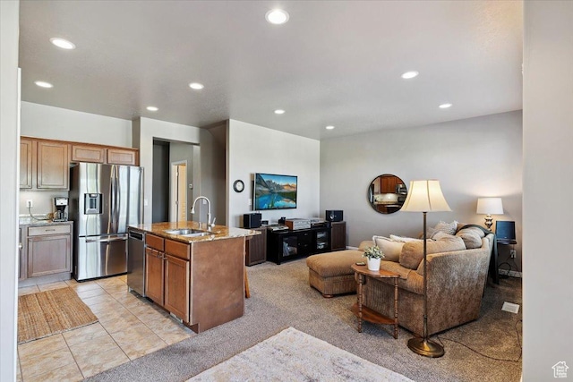 164 S 2875 W, West Point, UT 84015 - kitchen with appliances with stainless steel finishes, open floor plan, light stone countertops, recessed lighting, and a kitchen island with sink