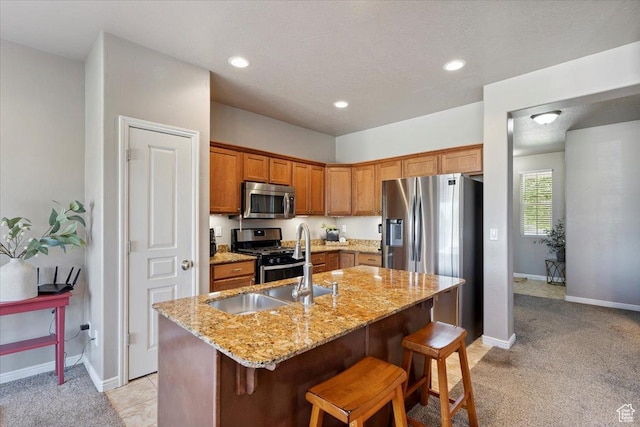 164 S 2875 W, West Point, UT 84015 - kitchen with appliances with stainless steel finishes, light colored carpet, an island with sink, light stone countertops, and recessed lighting