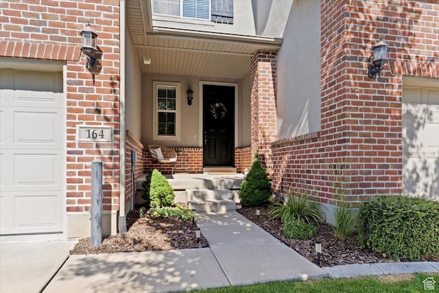 164 S 2875 W, West Point, UT 84015 - doorway to property with brick siding, stucco siding, and an attached garage