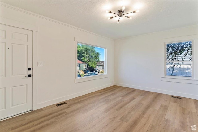 178 Country Club Dr, South Ogden, UT 84405 - empty room featuring light wood-style flooring, ornamental molding, and a textured ceiling