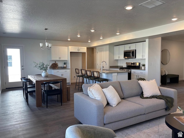 1536 E Pheasant Rd Unit 214, Eagle Mountain, UT 84005 - living area featuring wood finished floors, a textured ceiling, a chandelier, and recessed lighting