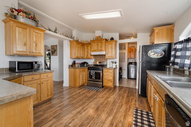 170 S 20300 W, Duchesne, UT 84021 - kitchen with appliances with stainless steel finishes, under cabinet range hood, washer / clothes dryer, and light wood-style floors