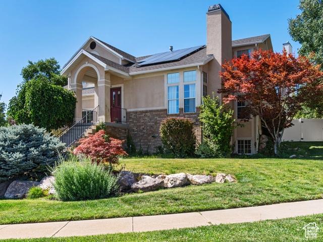 466 E 3460 N, North Ogden, UT 84414 - ranch-style home with solar panels, brick siding, stucco siding, and a chimney