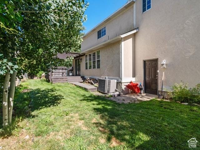 466 E 3460 N, North Ogden, UT 84414 - back of house featuring stucco siding, a yard, and a wooden deck