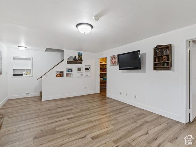 466 E 3460 N, North Ogden, UT 84414 - unfurnished living room with light wood-type flooring and baseboards