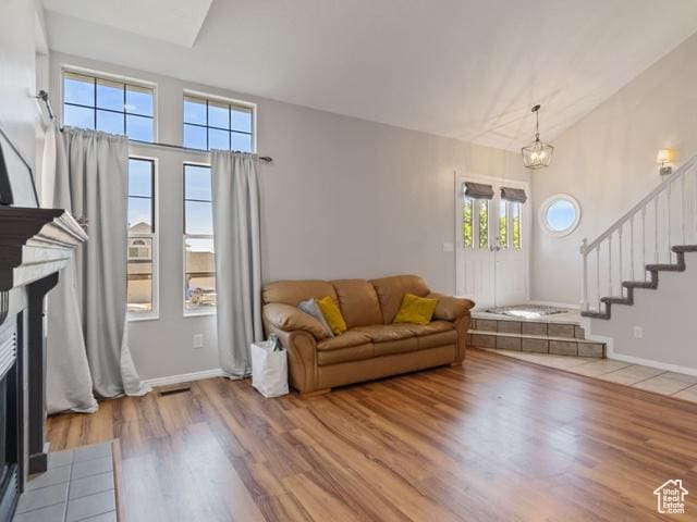 466 E 3460 N, North Ogden, UT 84414 - living area featuring a fireplace with flush hearth, wood finished floors, and stairs
