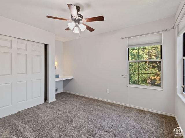 466 E 3460 N, North Ogden, UT 84414 - unfurnished bedroom featuring carpet floors, a closet, and a ceiling fan