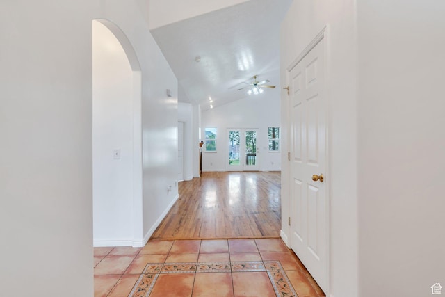 1430 S Heather Ln, Syracuse, UT 84075 - corridor with arched walkways, high vaulted ceiling, inlaid floor details, and light tile patterned floors
