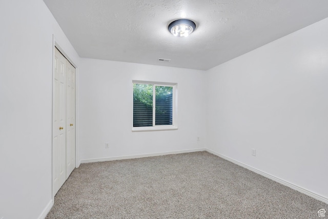 1430 S Heather Ln, Syracuse, UT 84075 - unfurnished bedroom with carpet floors, a textured ceiling, and a closet