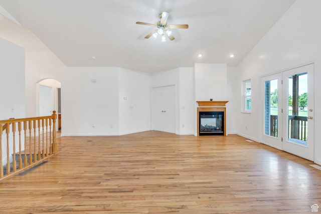 1430 S Heather Ln, Syracuse, UT 84075 - unfurnished living room featuring ceiling fan, light wood-style flooring, a glass covered fireplace, recessed lighting, and arched walkways