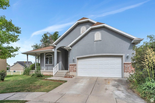 1430 S Heather Ln, Syracuse, UT 84075 - view of front of house featuring a garage, concrete driveway, stucco siding, and brick siding
