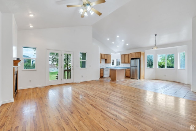 1430 S Heather Ln, Syracuse, UT 84075 - unfurnished living room with high vaulted ceiling, ceiling fan, light wood-type flooring, recessed lighting, and a glass covered fireplace