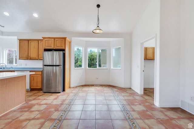 1430 S Heather Ln, Syracuse, UT 84075 - kitchen featuring freestanding refrigerator, healthy amount of natural light, light countertops, pendant lighting, and recessed lighting