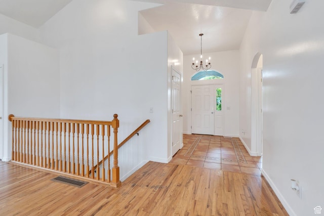 1430 S Heather Ln, Syracuse, UT 84075 - entryway with a chandelier, wood finished floors, and arched walkways