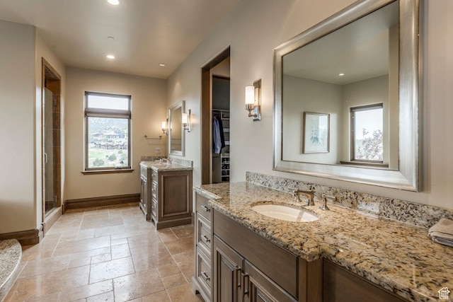 223 N Ibapah Peak Dr, Heber City, UT 84032 - full bath featuring two vanities, stone tile flooring, a stall shower, a spacious closet, and recessed lighting