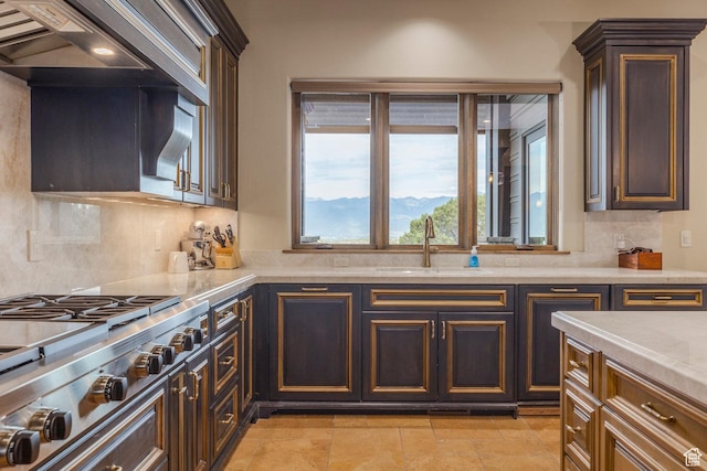 223 N Ibapah Peak Dr, Heber City, UT 84032 - kitchen featuring tasteful backsplash, stainless steel gas cooktop, dark brown cabinets, and light stone countertops