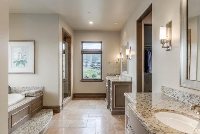 223 N Ibapah Peak Dr, Heber City, UT 84032 - bathroom featuring two vanities, a stall shower, a garden tub, stone tile flooring, and recessed lighting