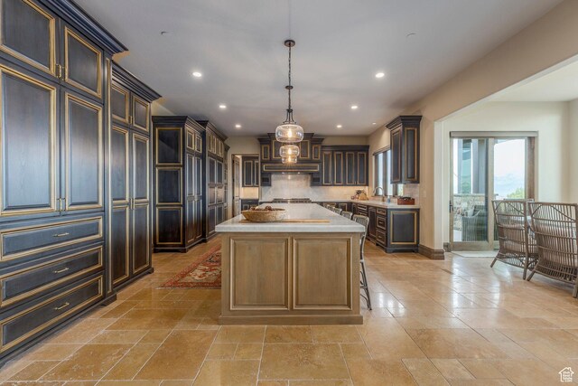 223 N Ibapah Peak Dr, Heber City, UT 84032 - kitchen featuring light countertops, recessed lighting, a kitchen island, tasteful backsplash, and stone tile floors