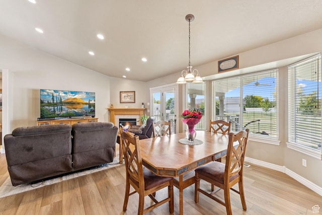 868 W Brandon Dr S, Kaysville, UT 84037 - dining space featuring light wood-style flooring, recessed lighting, lofted ceiling, and a glass covered fireplace