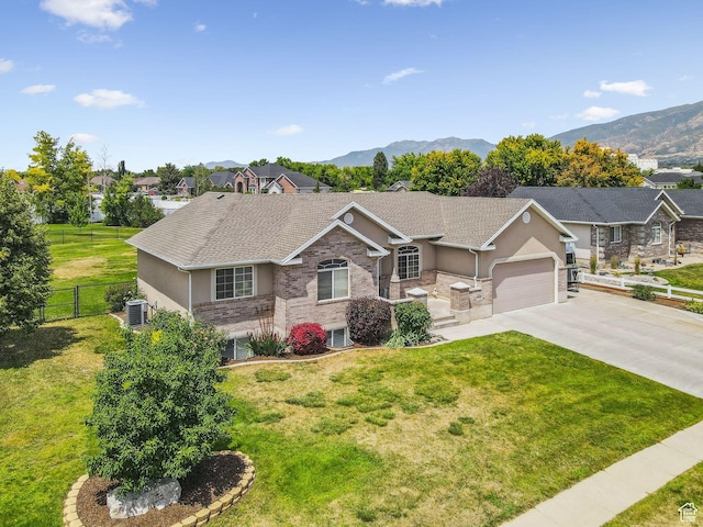 868 W Brandon Dr S, Kaysville, UT 84037 - view of front facade with stucco siding, driveway, a mountain view, and an attached garage