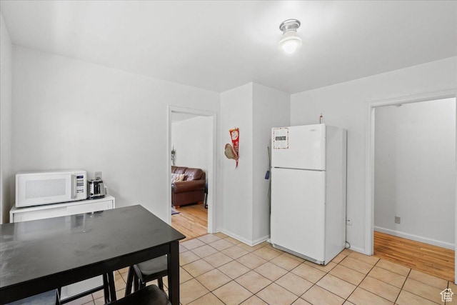 777 E 2nd Ave Unit 3, Salt Lake City, UT 84103 - kitchen featuring white appliances and light tile patterned flooring