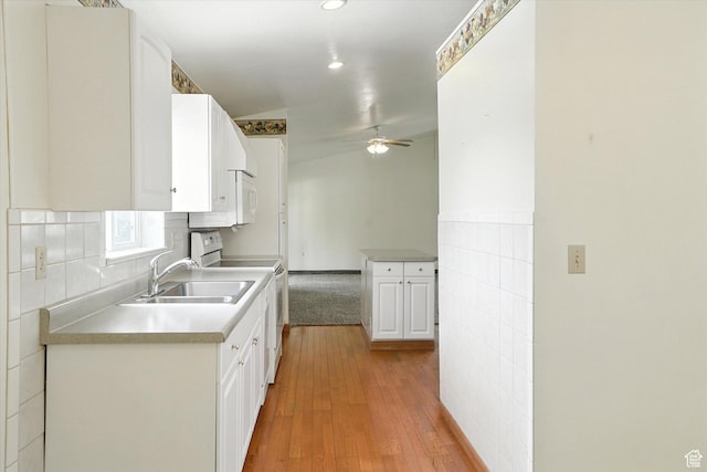 390 N 400 W, Malad City, ID 83252 - kitchen with range, ceiling fan, white cabinetry, light wood finished floors, and light countertops