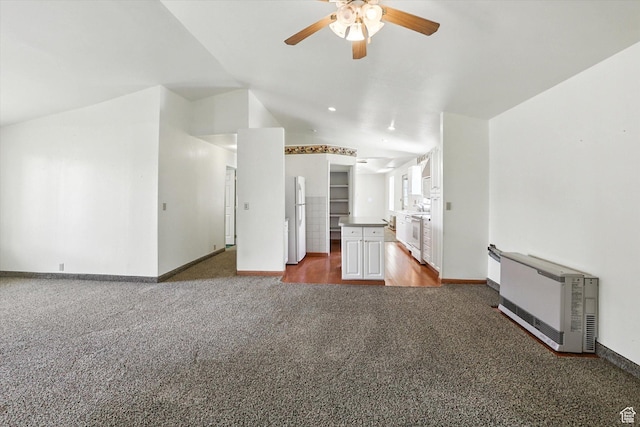 390 N 400 W, Malad City, ID 83252 - unfurnished living room featuring carpet, ceiling fan, vaulted ceiling, and heating unit