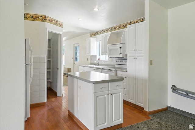 390 N 400 W, Malad City, ID 83252 - kitchen featuring white appliances, white cabinets, wood-type flooring, recessed lighting, and a center island