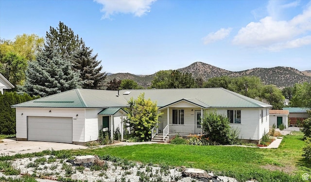 390 N 400 W, Malad City, ID 83252 - ranch-style house featuring an attached garage, a mountain view, driveway, a front lawn, and covered porch