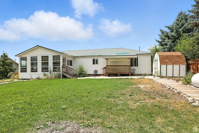 390 N 400 W, Malad City, ID 83252 - rear view of house with a storage shed, a deck, a yard, and a metal roof