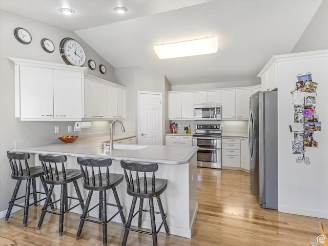 2287 N 470 E, Provo, UT 84604 - kitchen featuring stainless steel appliances, a peninsula, lofted ceiling, light countertops, and a kitchen breakfast bar