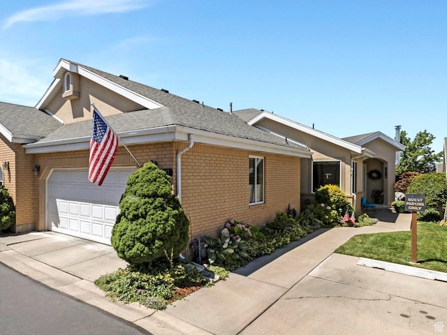 2287 N 470 E, Provo, UT 84604 - view of front of house with brick siding, a garage, driveway, and a shingled roof
