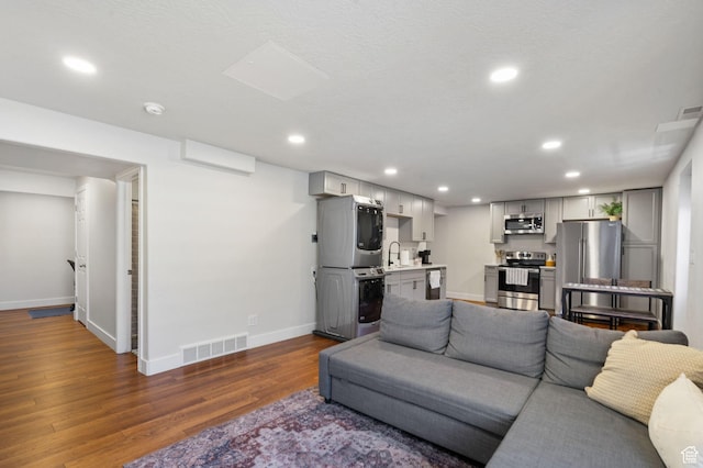 2344 E 1120 S, Spanish Fork, UT 84660 - living room featuring estacked washer and dryer, dark wood finished floors, and recessed lighting