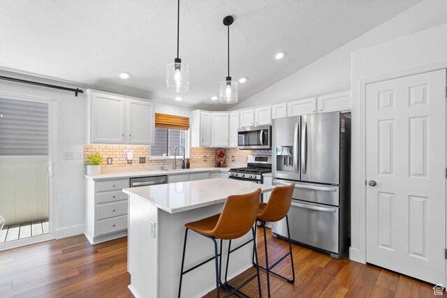 2344 E 1120 S, Spanish Fork, UT 84660 - kitchen featuring appliances with stainless steel finishes, decorative backsplash, lofted ceiling, dark wood finished floors, and a textured ceiling