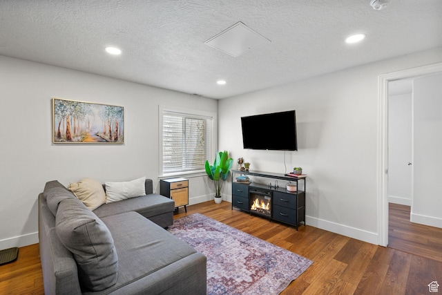 2344 E 1120 S, Spanish Fork, UT 84660 - living room featuring a textured ceiling, wood finished floors, recessed lighting, and a glass covered fireplace