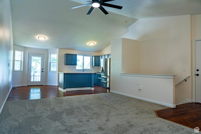 984 S 925 W, Woods Cross, UT 84087 - kitchen featuring stainless steel fridge, dark carpet, ceiling fan, blue cabinetry, and open floor plan