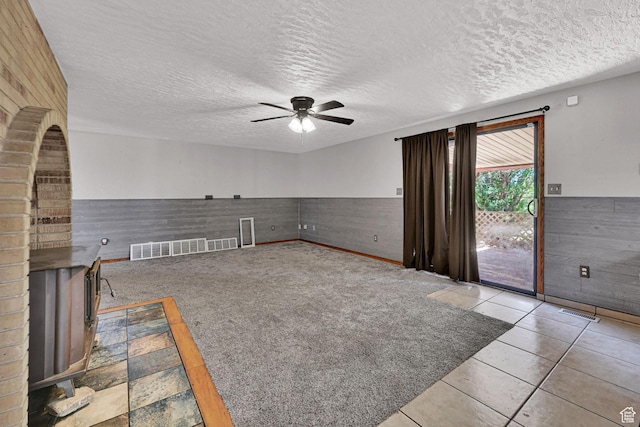 5577 W 4000 S, Hooper, UT 84315 - unfurnished living room featuring ceiling fan, a wainscoted wall, a textured ceiling, and wood walls