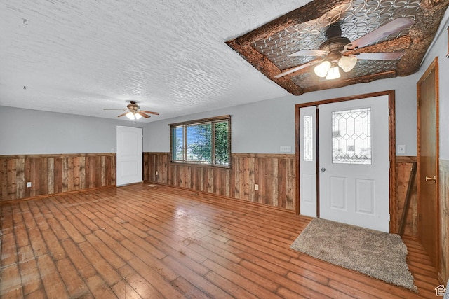 5577 W 4000 S, Hooper, UT 84315 - entrance foyer featuring ceiling fan, wainscoting, hardwood / wood-style floors, a textured ceiling, and wood walls