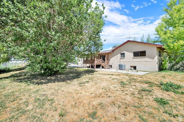 5577 W 4000 S, Hooper, UT 84315 - rear view of property with a deck, stairs, a yard, and brick siding