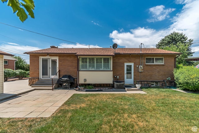 4269 S Vegas Way E, Holladay, UT 84124 - back of property featuring brick siding, a lawn, a patio area, and entry steps