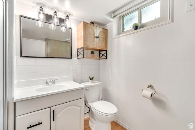 4269 S Vegas Way E, Holladay, UT 84124 - bathroom featuring backsplash, vanity, and wood finished floors