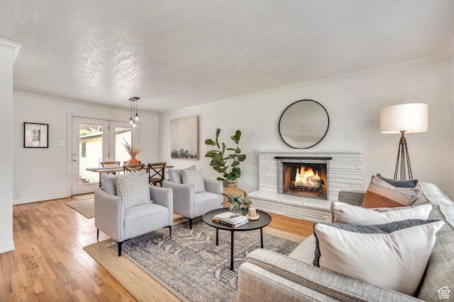 4269 S Vegas Way E, Holladay, UT 84124 - living room featuring light wood finished floors, a fireplace, crown molding, and a textured ceiling