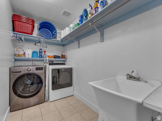8503 S Spiral Jetty Cir W Unit 2083, West Jordan, UT 84081 - laundry area featuring separate washer and dryer, tile patterned floors, and a textured ceiling