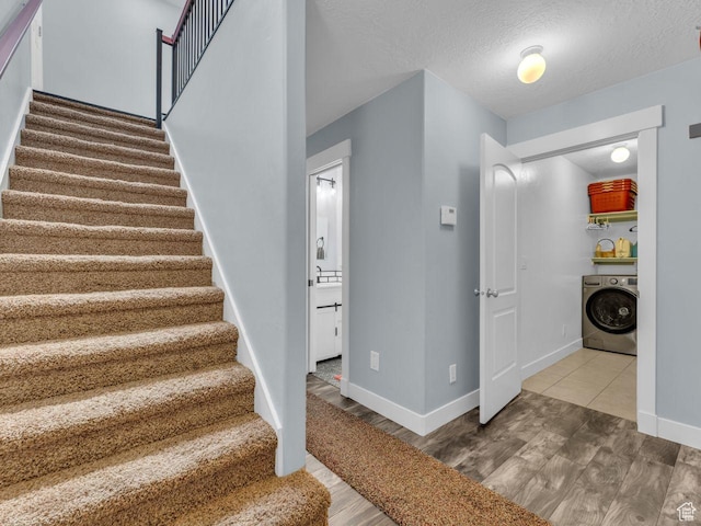 8503 S Spiral Jetty Cir W Unit 2083, West Jordan, UT 84081 - stairs featuring washer / clothes dryer, wood finished floors, and a textured ceiling
